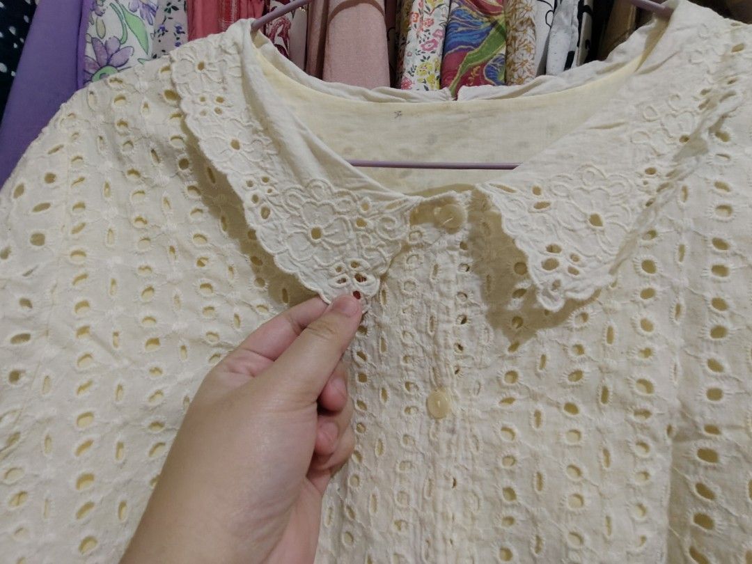 Cream Eyelet Peter Pan Collar Short Sleeve Blouse (Category: Blouses) located in Manila. Submitted by jadmcl (Listing ID 1447602804, Image 2). Description: - Cream collar - Short sleeves - Button-up front - Ruffled elastic hem detail - Sweet and vintage aesthetic - Versatile for casual or dressed-up occasions.