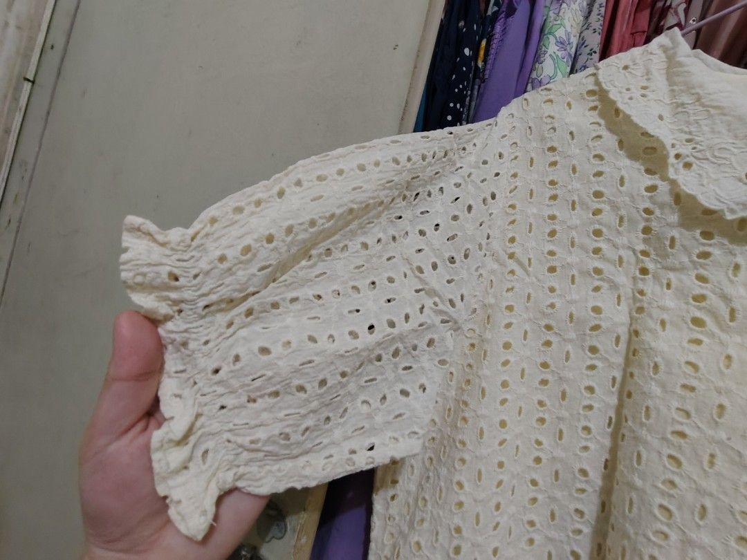 Cream Eyelet Peter Pan Collar Short Sleeve Blouse (Category: Blouses) located in Manila. Submitted by jadmcl (Listing ID 1447602804, Image 3). Description: - Cream collar - Short sleeves - Button-up front - Ruffled elastic hem detail - Sweet and vintage aesthetic - Versatile for casual or dressed-up occasions.
