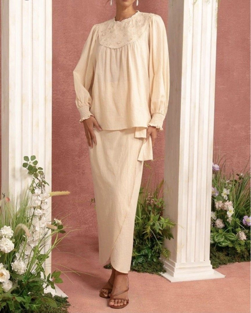 Cream Textured Long Sleeve Top & Skirt Set (Category: Sets or Coordinates) located in Kuala Lumpur. Submitted by hodorable (Listing ID 1447574255, Image 2). Description: - Cream textured top with puff sleeves and smocked cuffs. - Delicate floral embroidery around the neckline - Matching cream textured skirt with a wrap-style front. - Perfect for casual or semi-formal occasions. - Please refer to the size chart for accurate measurements. - Wrap sk