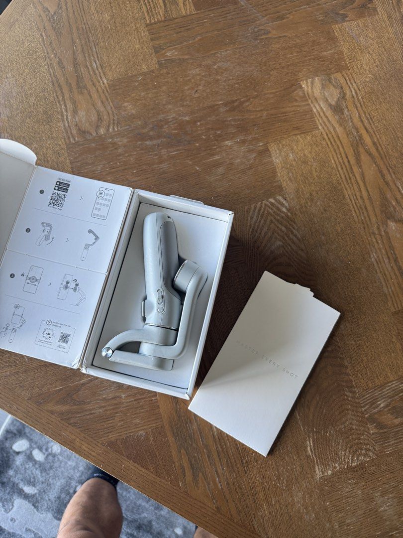 DJI Om 5 Gimbal Stabilizer (Category: Camera Bags & Carriers) located in Manila. Submitted by handoverfist (Listing ID 1447544748, Image 2). Description: This is a DJI OM 5 smartphone stabilizer, specifically the gray variant as shown on the box.The device features 3-axis stabilization and includes a built-in extension rod for selfies or higher-angle shots.It utilizes a magnetic clamp system to easily attach and detach your mobile phone..