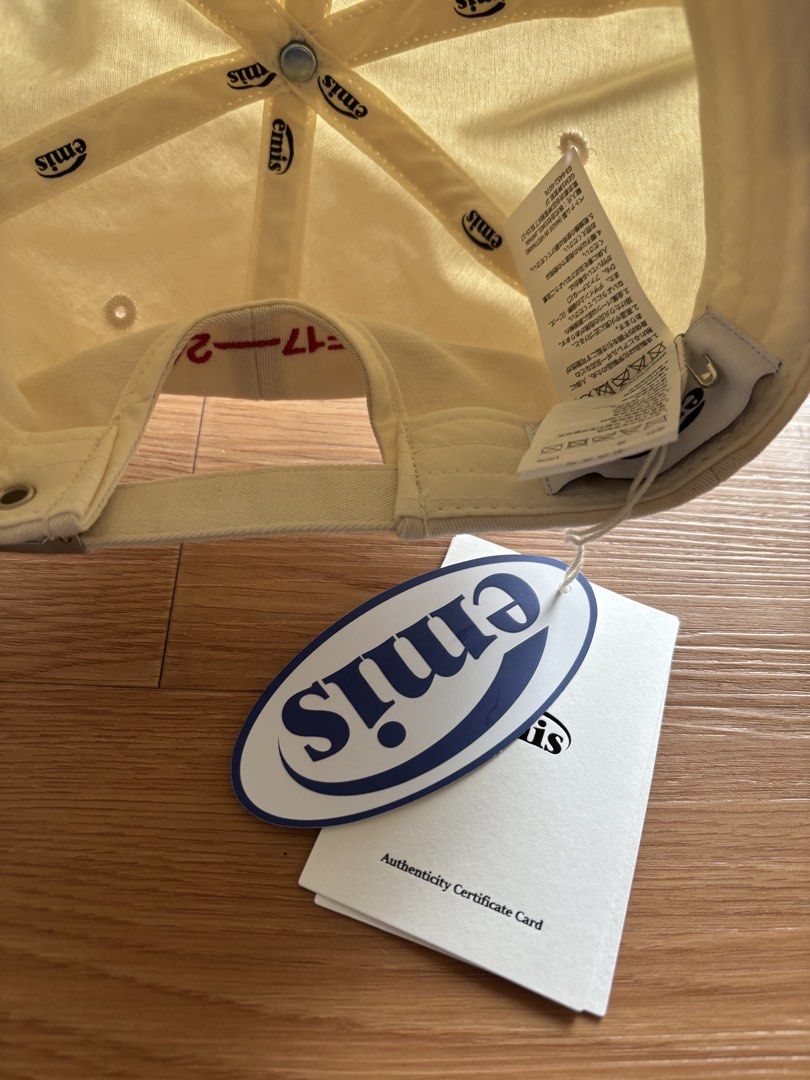 Emis Cap (Category: Caps & Hats) located in Singapore. Submitted by decluttertime17 (Listing ID 1447489293, Image 2). Description: - Brand: Emis - Type: Cap - Color: Cream/Beige - Logo: Red embroidered 'emis' - Condition: Excellent, like new - Style: Casual, versatile.