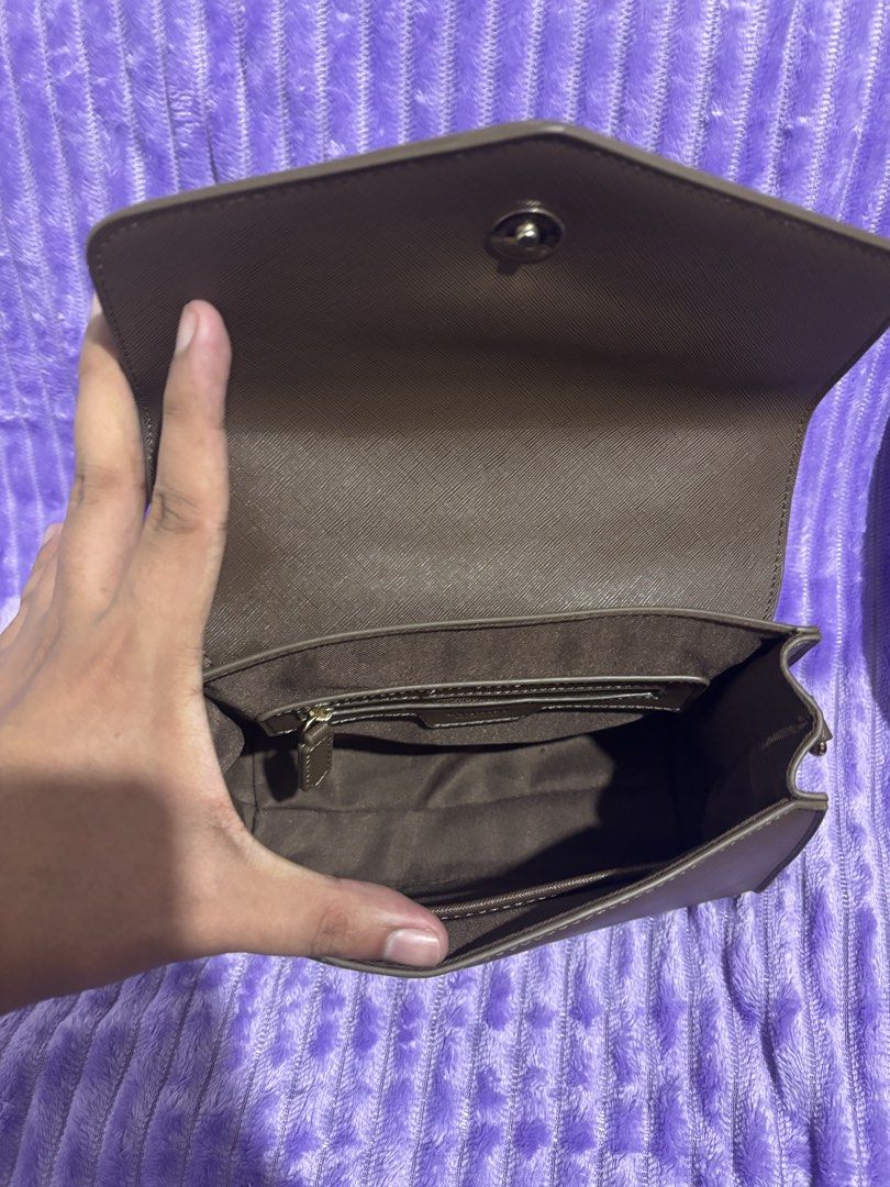 Esquire Brown Handbag with Orange Strap (Category: Luxury Bags & Wallets) located in Manila. Submitted by thecalvinedit (Listing ID 1410923900, Image 2). Description: Brown handbag with a top handle and a detachable orange strap. The bag has a flap closure and a small brand logo on the front. The strap has gold-colored hardware. It has a structured shape..