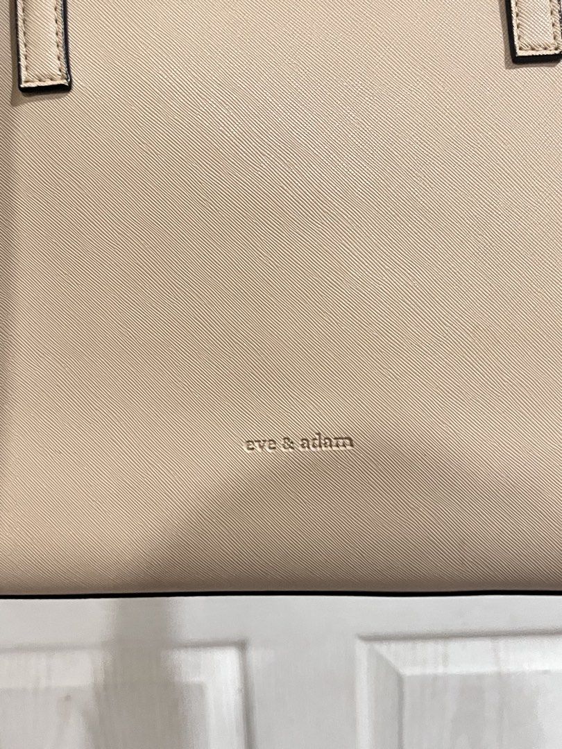 Eve & Adam Beige Vegan Leather Bag (Category: Tote Bags) located in General Santos City (Dadiangas). Submitted by shop.chieepreloved (Listing ID 1447484150, Image 3). Description: BOUGHT THIS FOR 1.8K VERY DURABLE - Beige Eve & Adam tote bag - Ideal for school or office use - Can fit Laptops - Interior is clean and well-maintained, EASY TO CLEAN ‼️ Handles have a little damage kasi yung rubber sa gilid na tanggal. CAN BE REPAIRED .