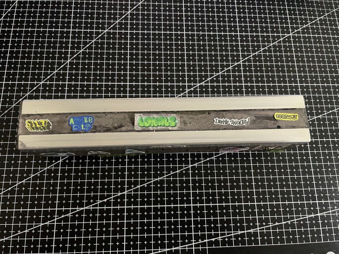 Fingerboard Obstacle Ledge (Category: Action & Battle Toys) located in Pasay City. Submitted by slideph (Listing ID 1447506698, Image 3). Description: - Handmade fingerboard obstacle - Realistic brick wall design - Features a durable metal coping - Decorated with cool, eye-catching stickers - Ideal for practicing fingerboard tricks - A unique addition to any fingerboarding or skateboarding setup.