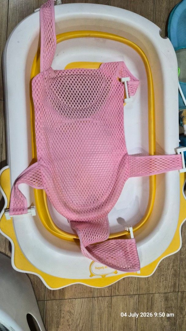 Foldable Baby Bathtub with Bath Net (Category: Bathtub & Bath Accessories) located in Pasig City. Submitted by missearly7 (Listing ID 1447487668, Image 3). Description: - White and yellow foldable baby bathtub - Includes pink mesh bath net for baby support - Legs fold for convenient storage - Perfect for making bath time enjoyable - Easy to clean and simple to use - safe for newborn - needs cleaning.