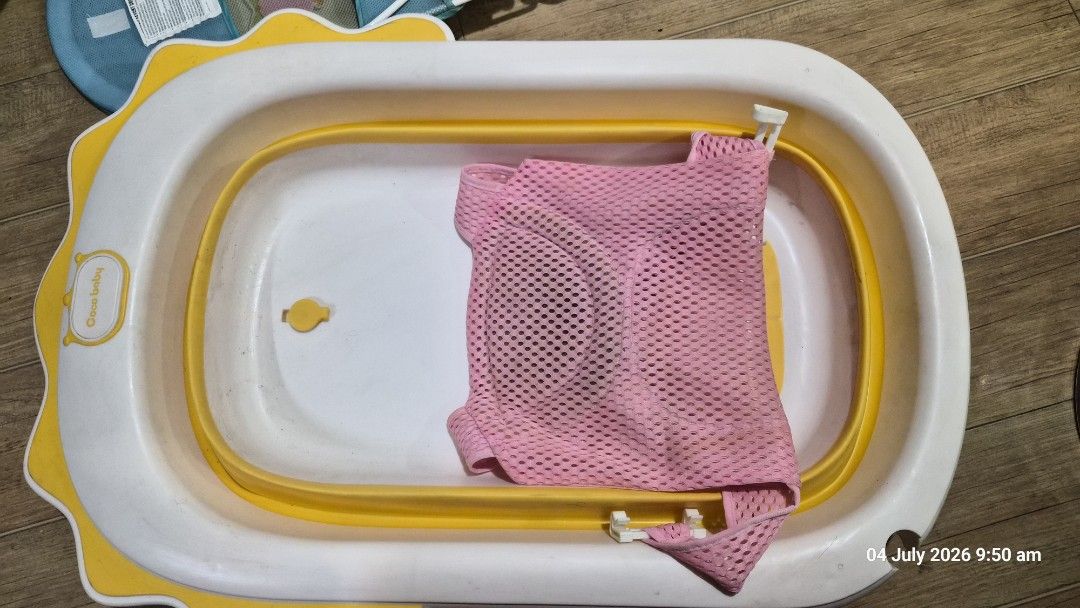 Foldable Baby Bathtub with Bath Net (Category: Bathtub & Bath Accessories) located in Pasig City. Submitted by missearly7 (Listing ID 1447487668, Image 2). Description: - White and yellow foldable baby bathtub - Includes pink mesh bath net for baby support - Legs fold for convenient storage - Perfect for making bath time enjoyable - Easy to clean and simple to use - safe for newborn - needs cleaning.
