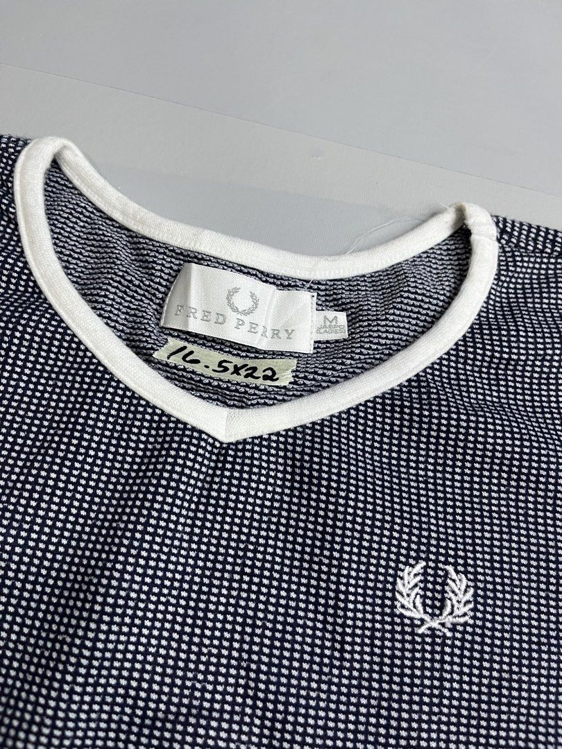 Fred Perry T-shirt Size M Navy White Checkered (Category: Tshirts & Polo Shirts ) located in Mabalacat. Submitted by aas_thriftfings (Listing ID 1447531833, Image 2). Description: - Fred Perry T-shirt - Size: Medium (M) - Color: Navy and white checkered pattern - Features: White trim on collar and sleeve cuffs - Iconic embroidered Fred Perry laurel wreath logo on chest - Material: Comfortable fabric - Ideal for: Casual wear.