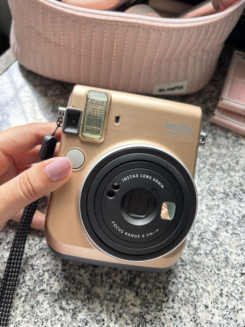 Fujifilm Instax Mini 70 Instant Camera - Gold (Category: Cameras) located in Taguig. Submitted by nisse (Listing ID 1447501103, Image 2). Description: - Fujifilm Instax Mini 70 instant camera - Rose gold color - Takes instant photos - Comes with a wrist strap 👉 IF INTERESTED PLS PM FOR MORE PHOTOS 👈 RFS: unused na, not sure if working pa. .