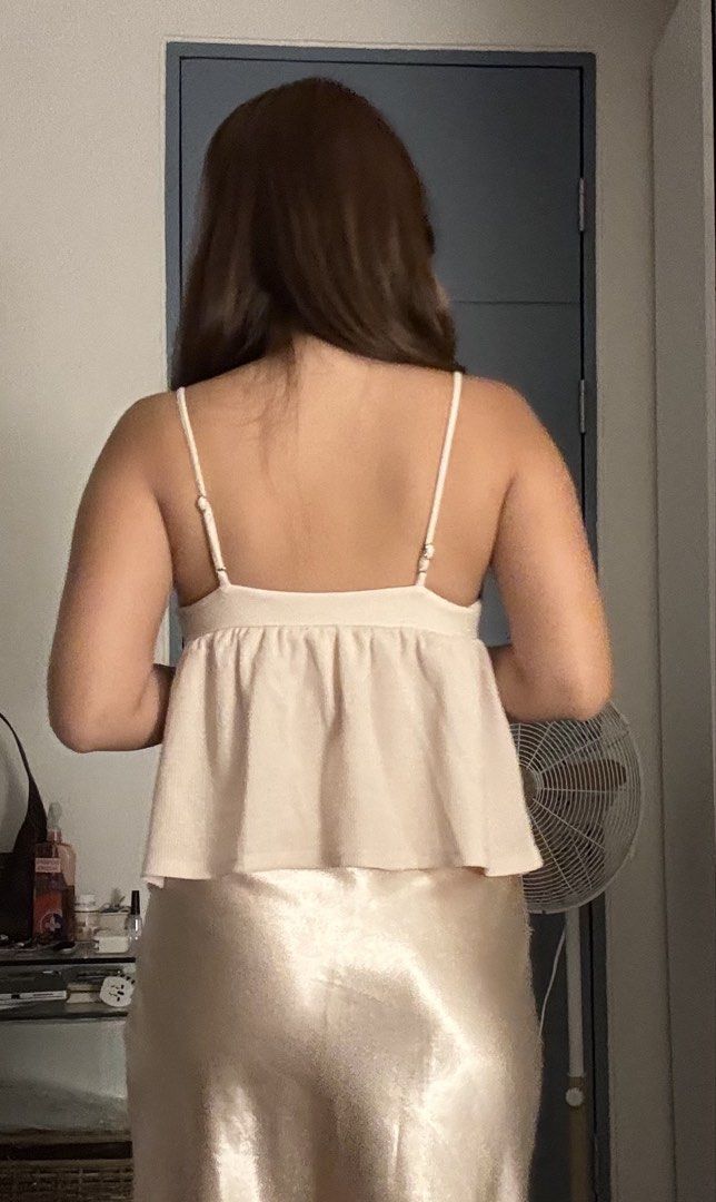 H&M Babydoll Top (Category: Sleeveless) located in Las Pinas. Submitted by fl0under_ (Listing ID 1447581135, Image 2). Description: - Cream colored cami top - Features a twist detail at the bust - Babydoll / Peplum style with a flowy hem - Adjustable spaghetti straps - Versatile: pairs well with skirts or jeans - Comfortable and stylish for any occasion loc: las pinas.