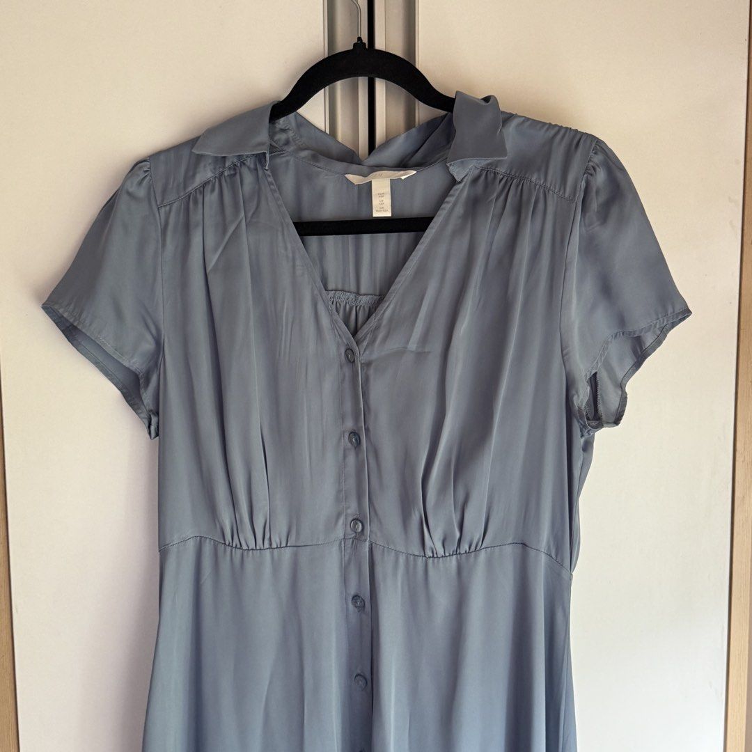 H&M Light Blue Satin Button-Up Shirt Dress (Category: Dresses) located in Quezon City. Submitted by shoppingwithj (Listing ID 1447496021, Image 2). Description: - Light blue H&M shirt dress - Short sleeves - Collared neckline - Button-up front - Cinched waist with a flowy skirt - Silky material feel - Perfect for dressing up or down.