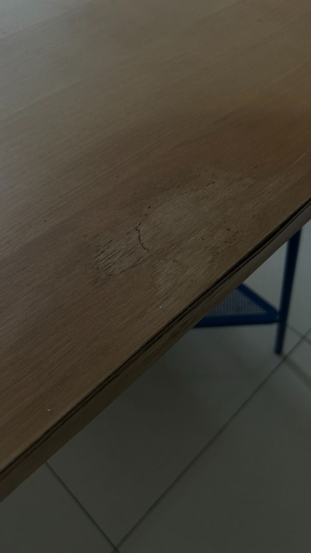IKEA Study Table (Category: Tables & Sets) located in Kuala Lumpur. Submitted by michieb (Listing ID 1447579527, Image 2). Description: Wood-top desk on blue triangular metal legs with mesh shelf. Some watermarks/light scratches on the tabletop — fully usable. .