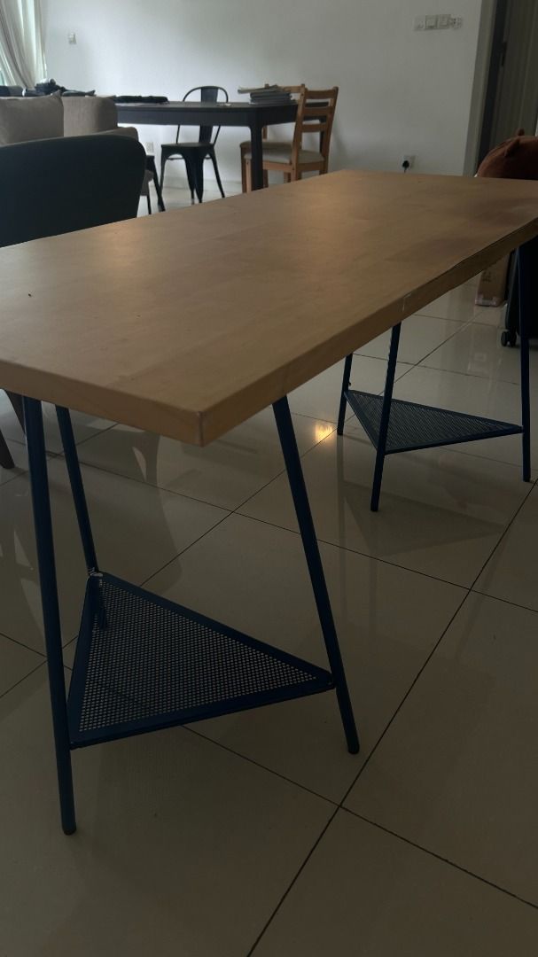 IKEA Study Table (Category: Tables & Sets) located in Kuala Lumpur. Submitted by michieb (Listing ID 1447579527, Image 1). Description: Wood-top desk on blue triangular metal legs with mesh shelf. Some watermarks/light scratches on the tabletop — fully usable. .