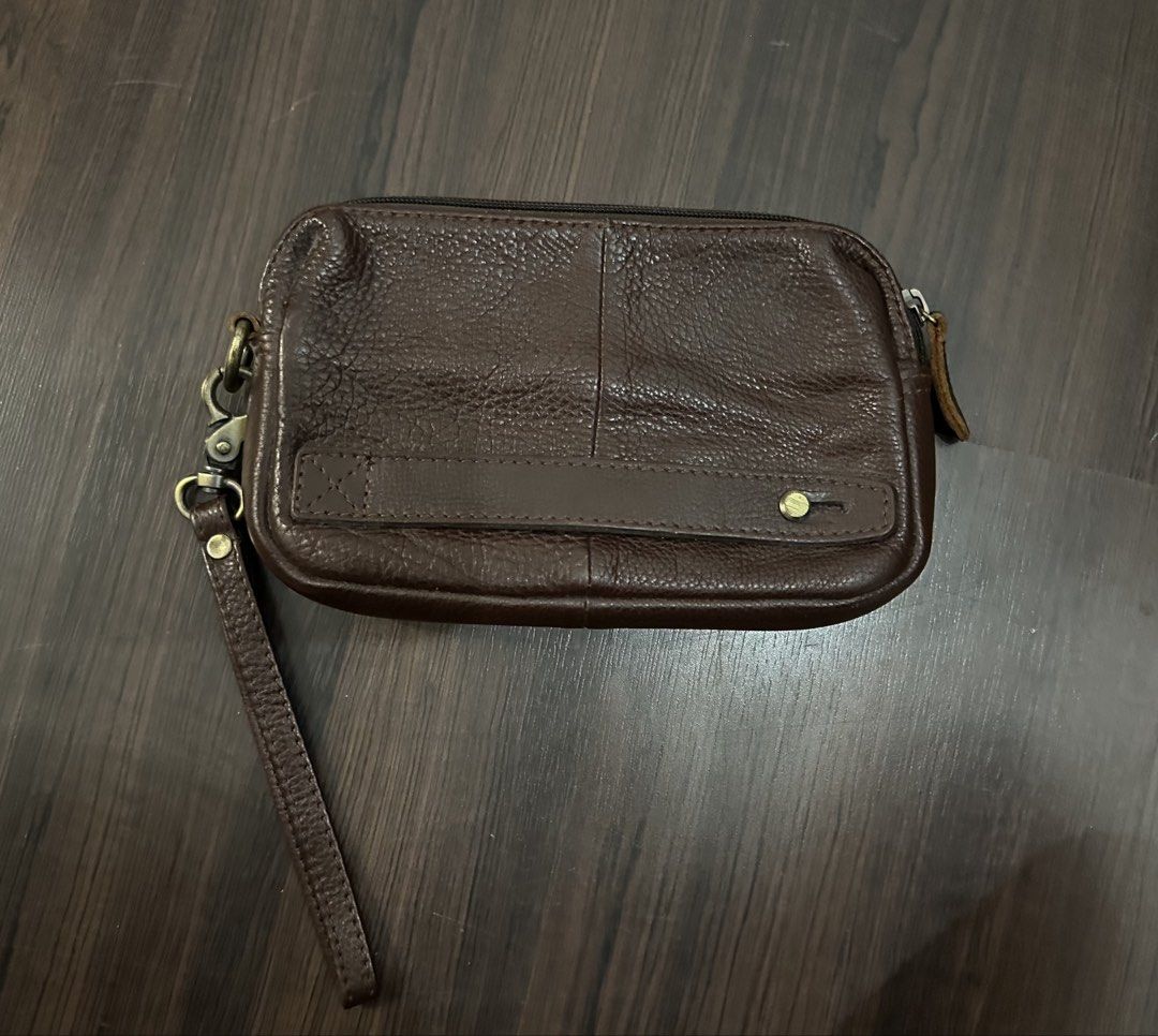 Kickers Brown Leather Wristlet Pouch (Category: Purses & Pouches) located in Batang Berjuntai. Submitted by sierrahunn (Listing ID 1447596584, Image 2). Description: - Kickers brown leather wristlet pouch - Main zip compartment - Front pocket - Interior lining with all-over Kickers logo print - Detachable wrist strap - Ideal for carrying daily essentials.