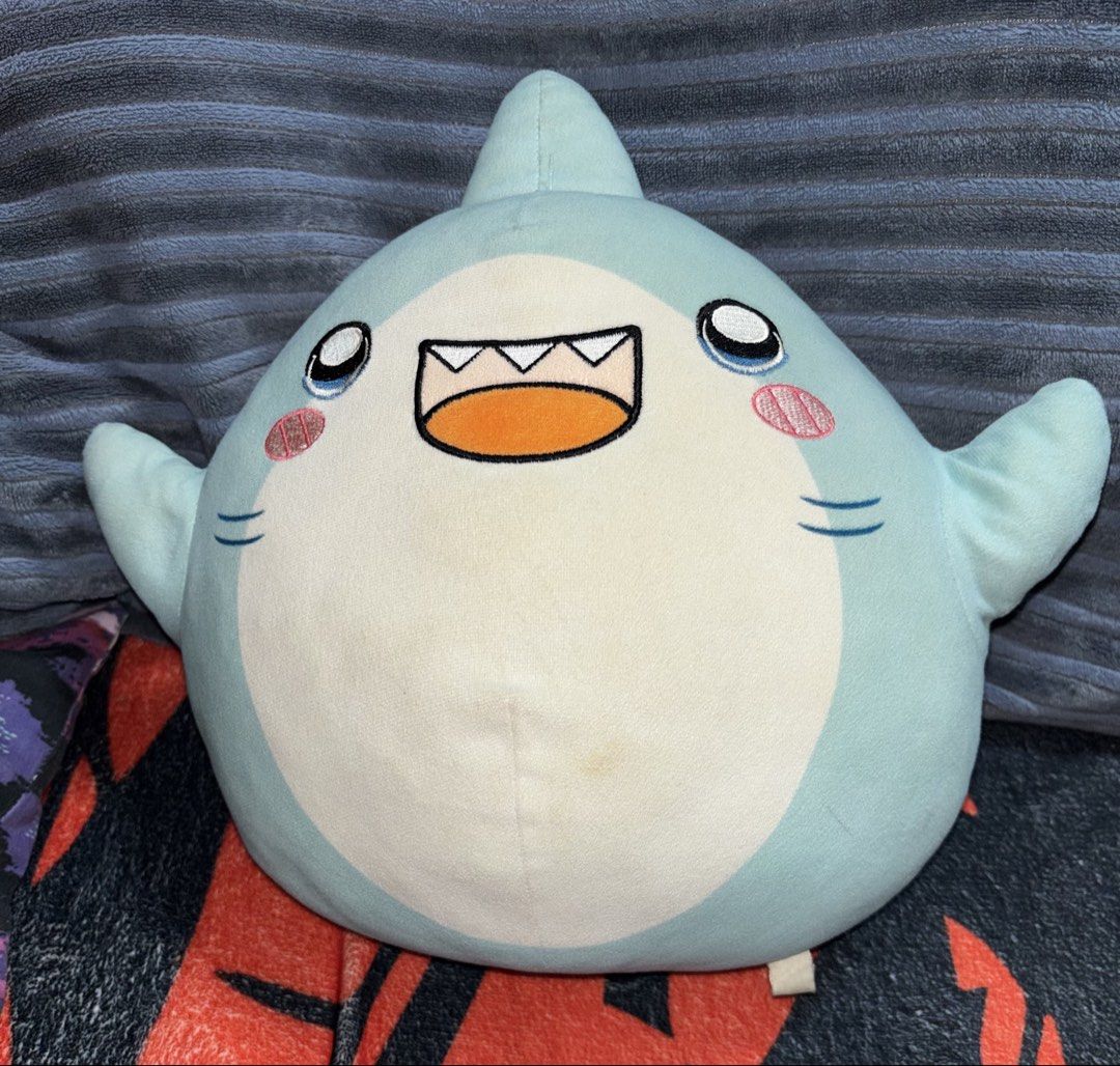 LankyBox Thicc Shark Plush Toy (Category: Plushies & Soft Toys) located in Cainta. Submitted by monica.bing (Listing ID 1447580592, Image 1). Description: - Adorable and squishy AUTHENTIC LankyBox Thicc Shark plush toy. - Features a cute light blue color and a happy face. - Ideal for cuddling or as a fun decorative piece. - Please note: there is a small stain on the back, as shown in the photos. Needs washing..