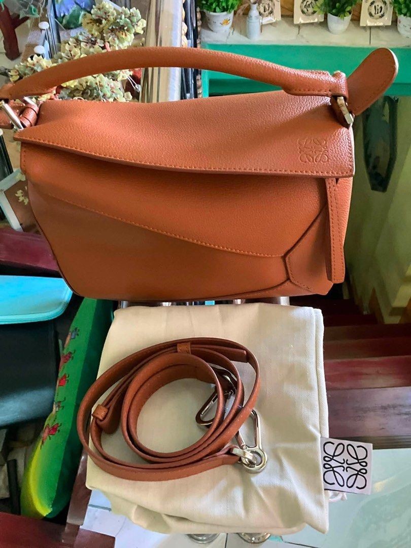 Loewe Small Puzzle Edge (Category: Luxury Bags & Wallets) located in Cabuyao City. Submitted by girliecloset202434 (Listing ID 1447588679, Image 2). Description: Brand: Loewe Color: Konjac/ Brown Condition: Rank S (no flaws), considered as bnew) Material: Pebbled Leather Inclusion/s: Dustbag only Coded✅ ( ask us for the picture) Please read ⬇️ Buy at your own risk! Shipping fee not included Last price upon request only for sure buyers! No return 