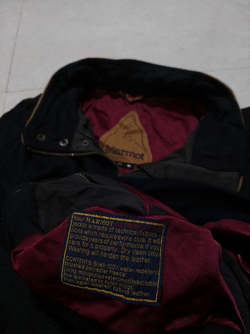 Marmot Black Bomber Jacket with Brown Accents (Category: Coats, Jackets and Outerwear) located in Quezon City. Submitted by jamtnf (Listing ID 1447643240, Image 2). Description: - Black Marmot jacket - Bomber style - Size: Medium (M) - Maroon lining - Brown leather accents on collar and pockets - Water repellent shell - Crushed polyester fleece content - Ideal for outdoor activities and casual wear - Care: Dry clean only; do not wash leather part