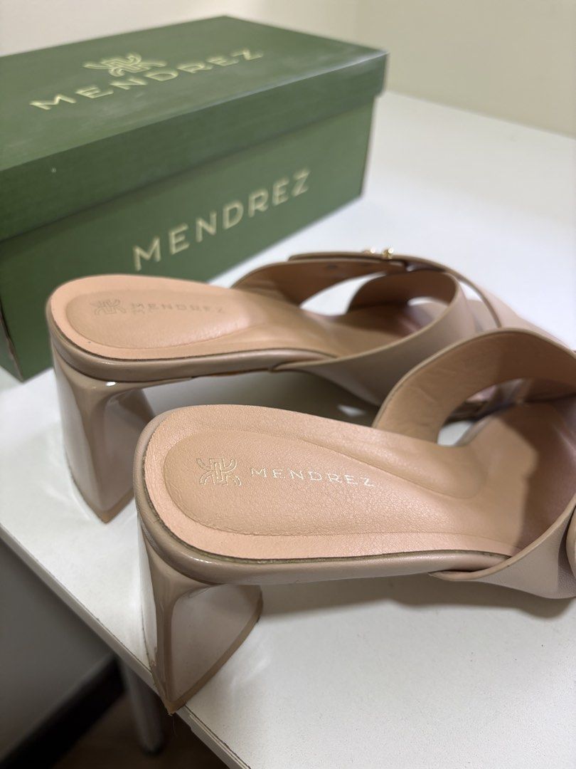 Size 7 - Mendrez Beige Cross Strap Block Heels with Box (Category: Heels) located in Mandaluyong City. Submitted by twonett (Listing ID 1447563570, Image 3). Description: - Bought for 1,500 - Used once - Chic beige Mendrez heels - Stylish cross strap design with gold stud accents - Comfortable and stable chunky block heel - Easy slip-on style for convenience - Comes with the original Mendrez box.
