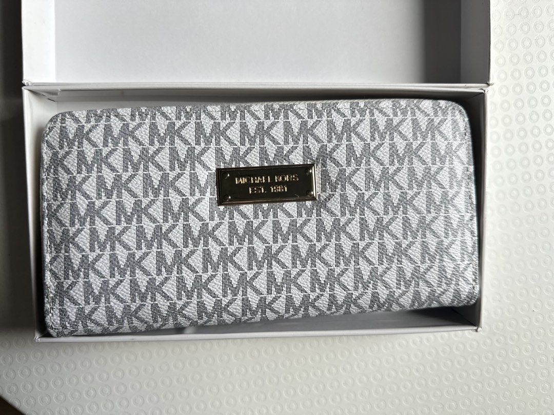 Michael Kors Monogram Zip Around Wallet (Category: Wallets & Card holders) located in Mandaluyong City. Submitted by TheWeekendProject (Listing ID 1447507678, Image 1). Description: - Michael Kors wallet - Classic MK monogram print (white & grey) - Gold hardware - Zip-around closure - Multiple interior card slots - Zippered coin pocket - Comes with original box - Ideal for organizing essentials - Great for gifting - Note: No tags inside and it is