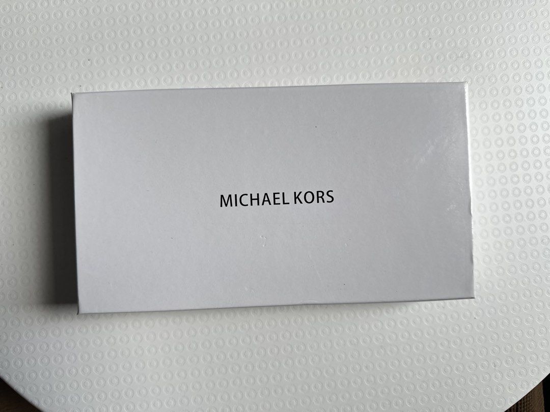 Michael Kors Monogram Zip Around Wallet (Category: Wallets & Card holders) located in Mandaluyong City. Submitted by TheWeekendProject (Listing ID 1447507678, Image 2). Description: - Michael Kors wallet - Classic MK monogram print (white & grey) - Gold hardware - Zip-around closure - Multiple interior card slots - Zippered coin pocket - Comes with original box - Ideal for organizing essentials - Great for gifting - Note: No tags inside and it is