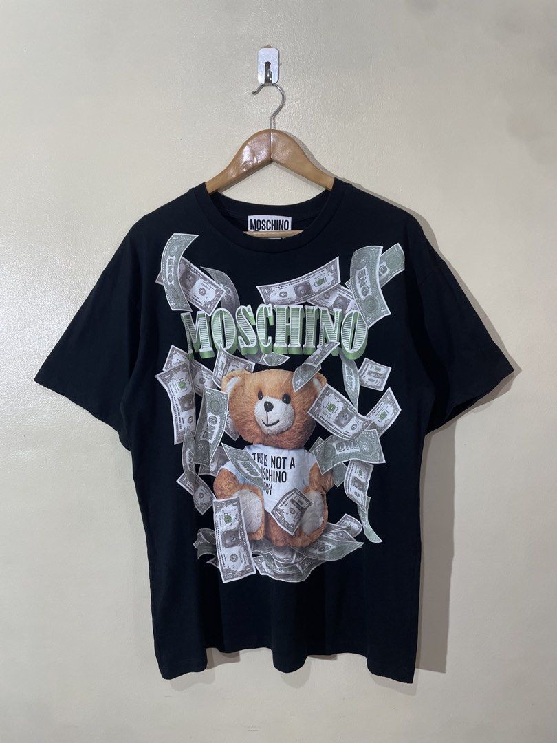 MOSCHINO DOLLAR TEDDY BEAR SHIRT (Category: Luxury Apparel) located in Valenzuela. Submitted by secret_closet_ph (Listing ID 1447660445, Image 1). Description: MOSCHINO DOLLAR TEDDY BEAR SHIRT LARGE FITTING L29 W22 9/10 CONDITION 749 PESOS.
