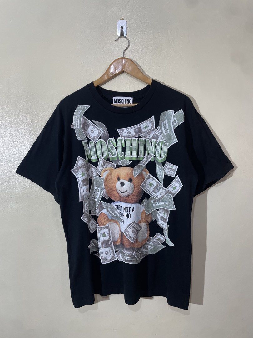 MOSCHINO DOLLAR TEDDY BEAR SHIRT (Category: Luxury Apparel) located in Valenzuela. Submitted by secret_closet_ph (Listing ID 1447660445, Image 3). Description: MOSCHINO DOLLAR TEDDY BEAR SHIRT LARGE FITTING L29 W22 9/10 CONDITION 749 PESOS.