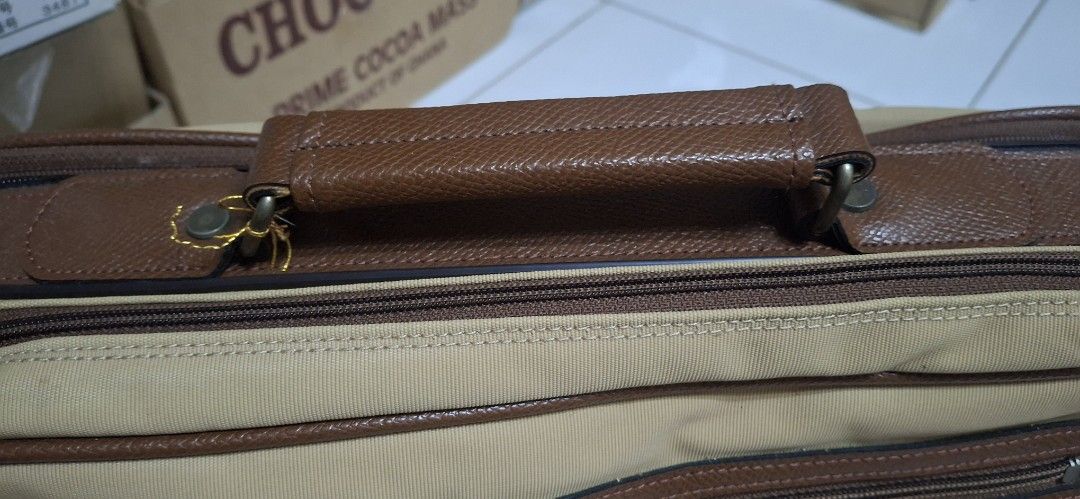 Murdock Tan Canvas Leather Trim Messenger Bag (Category: Sling Bags) located in Manila. Submitted by youngcloud_b1fffa (Listing ID 1447657590, Image 2). Description: - Tan Murdock messenger bag - Brown leather accents - Multiple zippered compartments on the front - Top handle and adjustable shoulder strap - Spacious interior with a divider - Ideal for work or travel - Good size for essentials "R&B Mix Japan Surplus Items".
