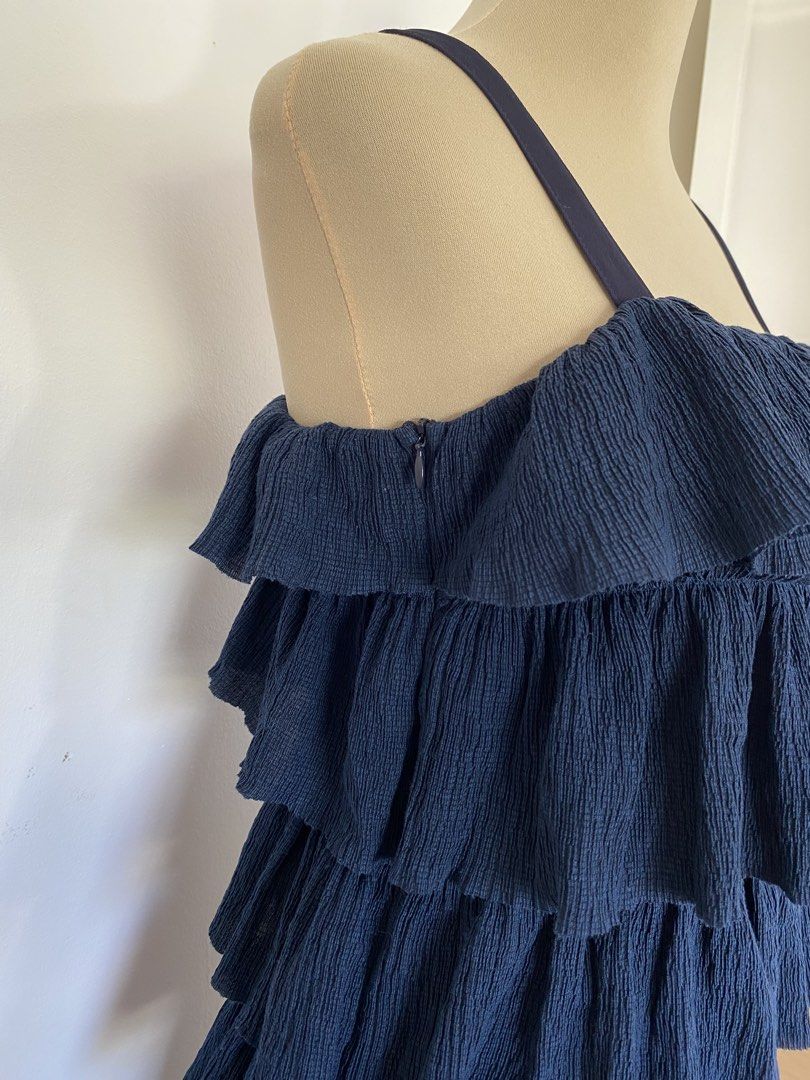 Navy Blue Tiered Ruffle Cold Shoulder Dress (Category: Dresses) located in Santa Rosa. Submitted by summerbrunch (Listing ID 1447470078, Image 2). Description: BUY WORTH 1K, GET FREE SHIPPING! EXCEPT FOR STROLLER BAG Mannequin size: MEDIUM Has side zipper super chic!! with full inner lining - Navy blue dress - Multiple tiers of ruffles - Cold shoulder design - Adjustable straps - Side zipper closure - Crinkled fabric texture - Ideal for parties o