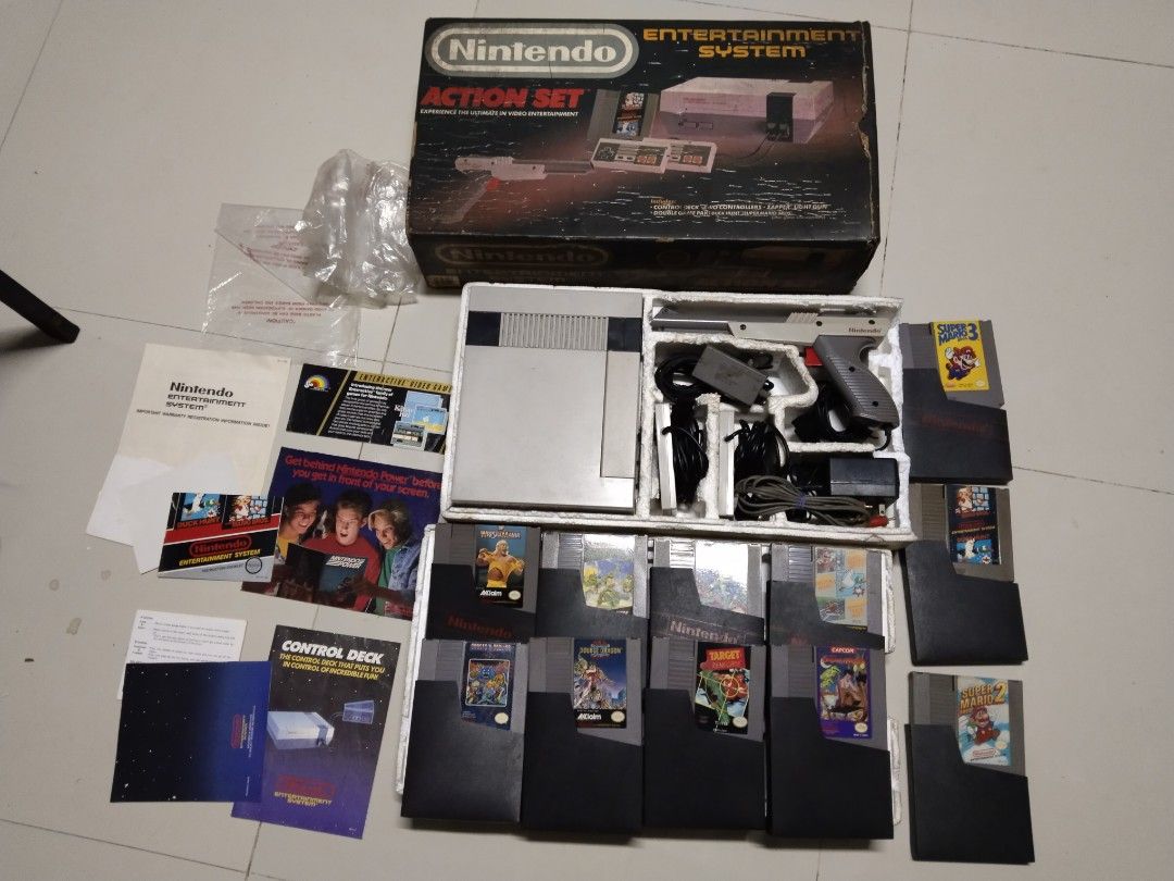 NES Nintendo Entertainment System Action Set with Games (Category: Nintendo) located in Manila. Submitted by megazordbuilderhunter (Listing ID 1447598127, Image 1). Description: price 15,000 CONDITION: tested working gray pa ang unit medyo matifas na ang wire pero walang ngatngat zapper working tested with cs adaptor 110v box condition 6/10 styro 5/10 INCLUSION -UNIT with box and inserts and plastic bag insides - 2pcs controllers -1 zapper - av c