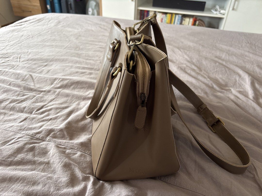 Ni QUA Custom Mezzo Medium Bag (Category: Tote Bags) located in San Pedro. Submitted by rissy0205 (Listing ID 1447493184, Image 2). Description: - Brand: Ni QUA - Color: Taupe - Genuine leather - Structured but lightweight - Double compartment with magnetic enclosure for both sizes - Internal: partially lined in the middle part - Estimated bag weight: 750 grams - Size: 10″H x 12″W x 6″D with handle drop of 6″ - With dust bag - Bought for around P