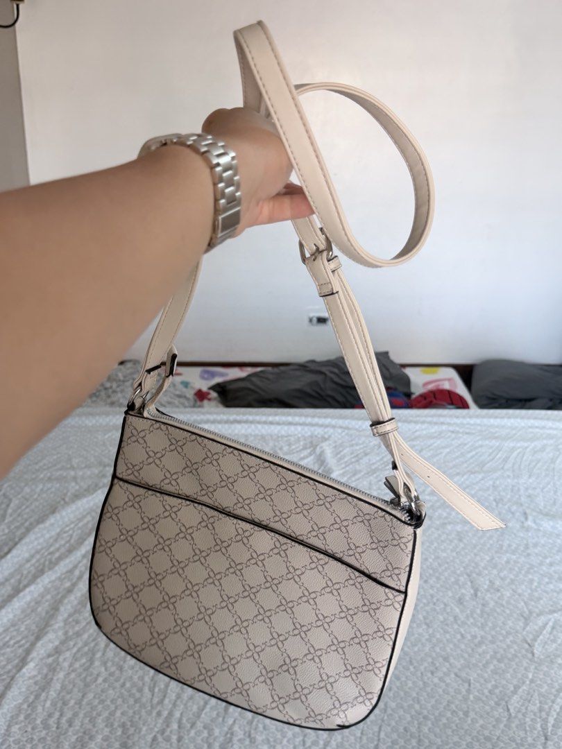 Nine West Beige Monogram Crossbody Bag (Category: Cross-body Bags) located in Quezon City. Submitted by fabeelousph (Listing ID 1447479078, Image 2). Description: - Beige Nine West crossbody bag - Features Nine West logo on the front - Patterned design on the lower half - Two zippered pockets on the front - Adjustable strap - Ideal for everyday use.