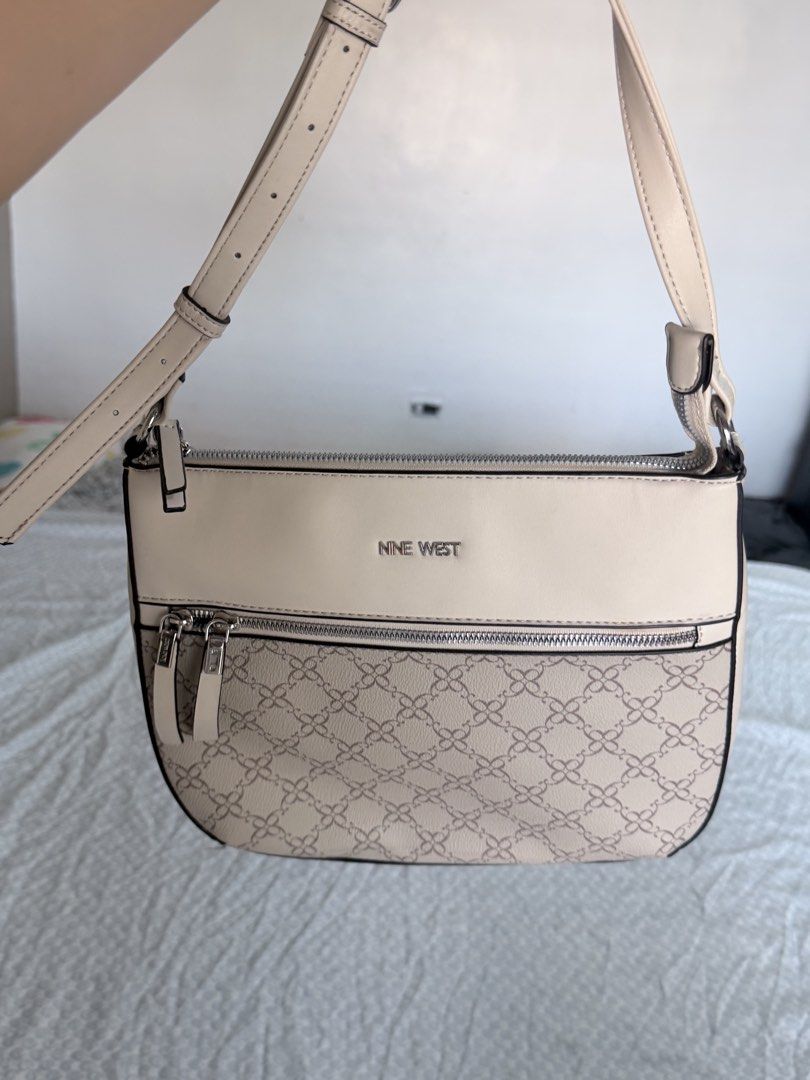 Nine West Beige Monogram Crossbody Bag (Category: Cross-body Bags) located in Quezon City. Submitted by fabeelousph (Listing ID 1447479078, Image 1). Description: - Beige Nine West crossbody bag - Features Nine West logo on the front - Patterned design on the lower half - Two zippered pockets on the front - Adjustable strap - Ideal for everyday use.