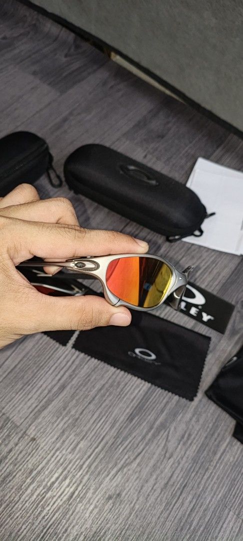 Oakley Juliet1 Sunglasses with complete inclusions (Category: Sunglasses & Eyewear) located in Manila. Submitted by ererane19 (Listing ID 1447497728, Image 3). Description: - 1 pair of iconic Oakley Juliet sunglasses - Includes original hard cases and soft pouches for both pairs - One pair features striking red lenses - The other pair comes with vibrant orange/yellow lenses - Perfect for Oakley collectors and enthusiasts - All accessories visible