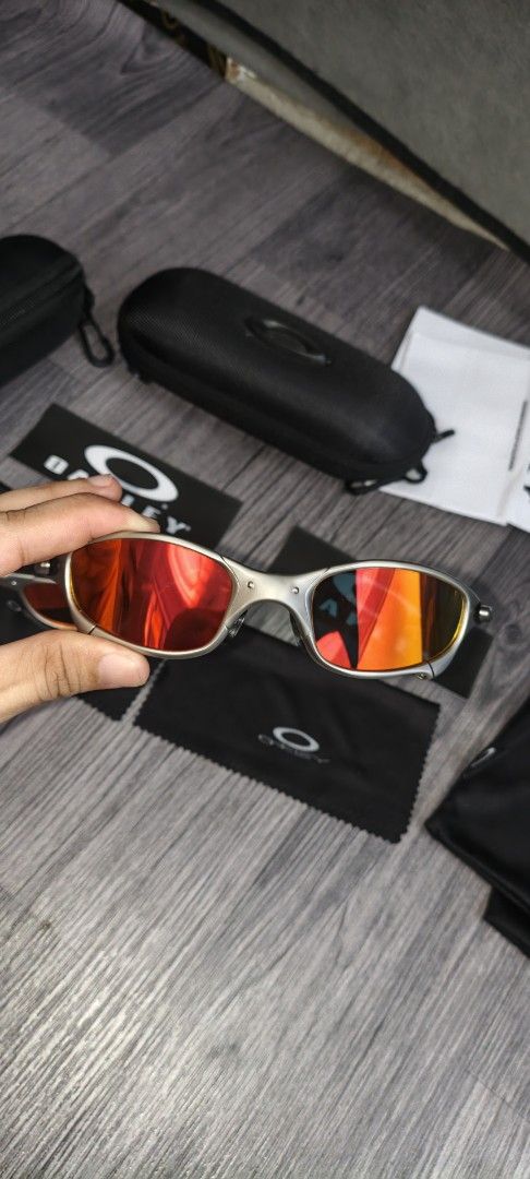 Oakley Juliet1 Sunglasses with complete inclusions (Category: Sunglasses & Eyewear) located in Manila. Submitted by ererane19 (Listing ID 1447497728, Image 2). Description: - 1 pair of iconic Oakley Juliet sunglasses - Includes original hard cases and soft pouches for both pairs - One pair features striking red lenses - The other pair comes with vibrant orange/yellow lenses - Perfect for Oakley collectors and enthusiasts - All accessories visible