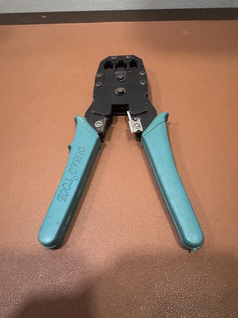 OUBAO TOOL RJ45 Crimping Tool for Network Cables (Category: Home Improvement Tools & Accessories) located in Manila. Submitted by kuroshirooreo (Listing ID 1447572577, Image 1). Description: - Network cable crimping tool - Works with RJ45 connectors - Built-in wire cutter and stripper - Features turquoise handles - Ideal for DIY ethernet cable creation - Tested and confirmed working.