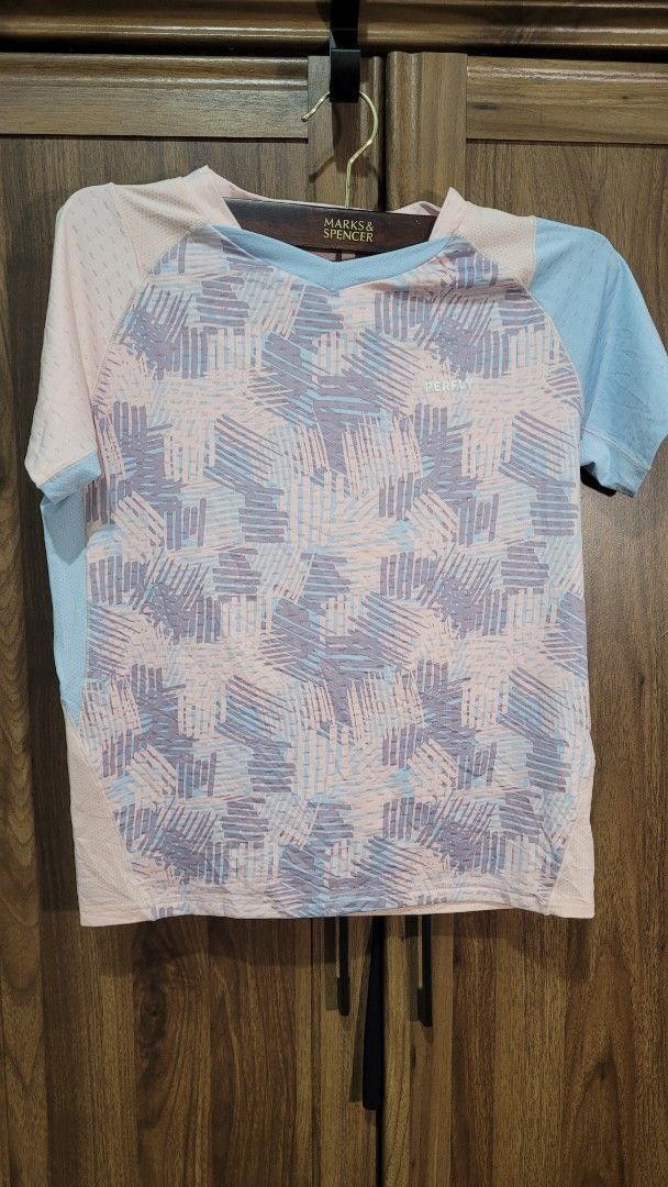 PERFLY Decathlon Kids Junior T-shirt (Category: Babies & Kids Fashion) located in Davao. Submitted by NearlyNew (Listing ID 1447589778, Image 1). Description: - Lightweight and breathable kids t-shirt from Decathlon - Features a cool abstract geometric print in pink, blue, and grey - Mesh-like texture for excellent ventilation - Ideal for sports activities or everyday casual wear - Tag indicates Junior size: 12-13 years.
