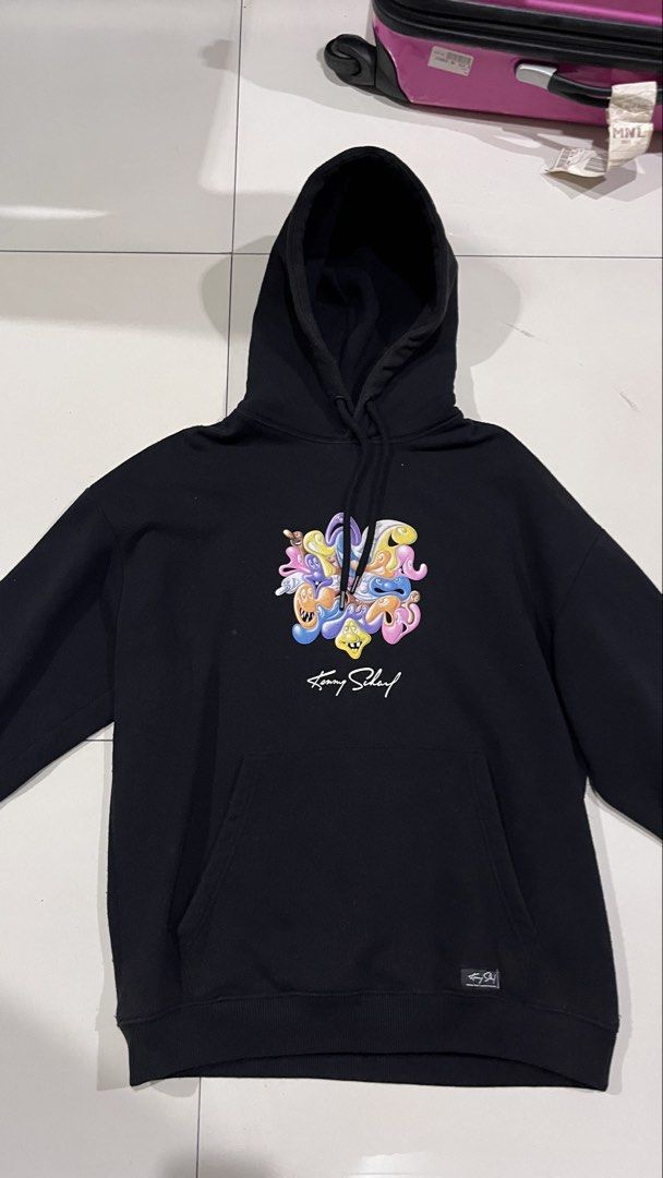 Pull & Bear x Kenny Scharf Black Graphic Hoodie (Category: Hoodies) located in Manila. Submitted by sergeboysells (Listing ID 1447649924, Image 2). Description: - Authentic Kenny Scharf x Pull & Bear collaboration hoodie. - Features eye-catching graphic print on both front and back. - Includes artist Kenny Scharf's signature. - Practical front pocket and adjustable hood drawstrings. - Ideal for everyday casual wear..