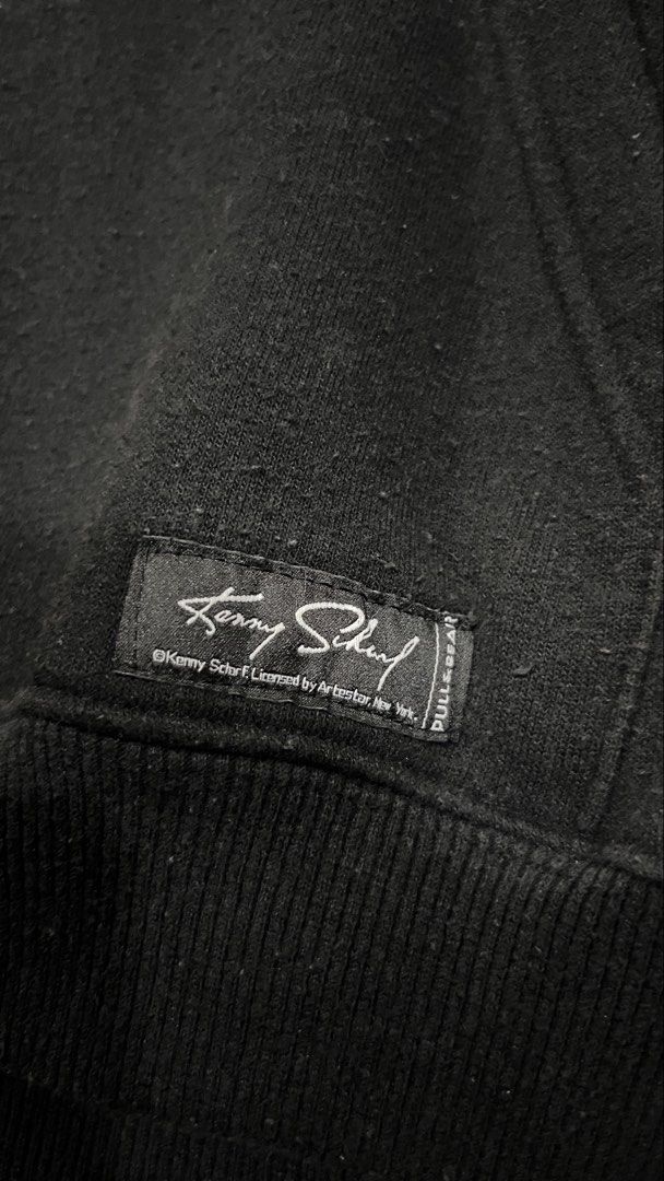 Pull & Bear x Kenny Scharf Black Graphic Hoodie (Category: Hoodies) located in Manila. Submitted by sergeboysells (Listing ID 1447649924, Image 3). Description: - Authentic Kenny Scharf x Pull & Bear collaboration hoodie. - Features eye-catching graphic print on both front and back. - Includes artist Kenny Scharf's signature. - Practical front pocket and adjustable hood drawstrings. - Ideal for everyday casual wear..
