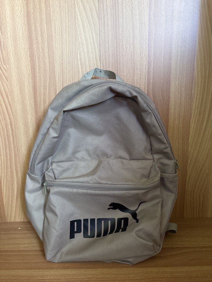 Puma Backpack Grey authentic (Category: Backpacks) located in Vigan. Submitted by aizyyy09 (Listing ID 1447477682, Image 1). Description: - Grey Puma backpack - Front zip pocket for easy access - Side mesh pocket for water bottle or umbrella - Iconic Puma logo prominently displayed on the front - Ample space inside for books, essentials, and more - Ideal for school, work, or everyday adventures.