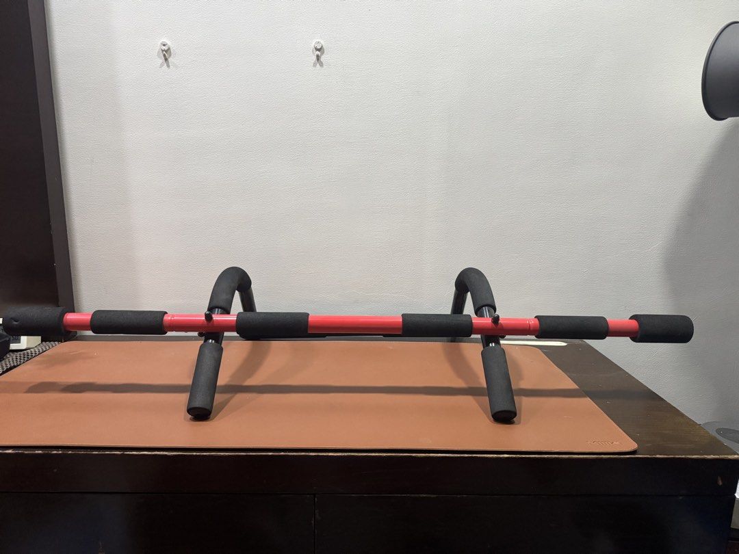 Red Doorway Pull-up Bar with Foam Grips (Category: Weights & Dumbbells) located in Manila. Submitted by kuroshirooreo (Listing ID 1447587620, Image 2). Description: - Adjustable doorway pull-up bar - Sturdy red metal frame - Comfortable black foam grips - Easy to install and remove - Ideal for home workouts: pull-ups, chin-ups, and more.