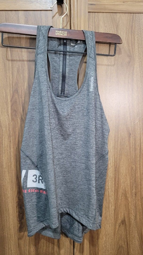 Reebok Racerback Grey Workout Tank Top Size S (Category: Activewear) located in Davao. Submitted by NearlyNew (Listing ID 1447510705, Image 2). Description: - Grey Reebok racerback tank top - Size S - Front zip detail - Perforated side panels - Ideal for workouts or casual wear.
