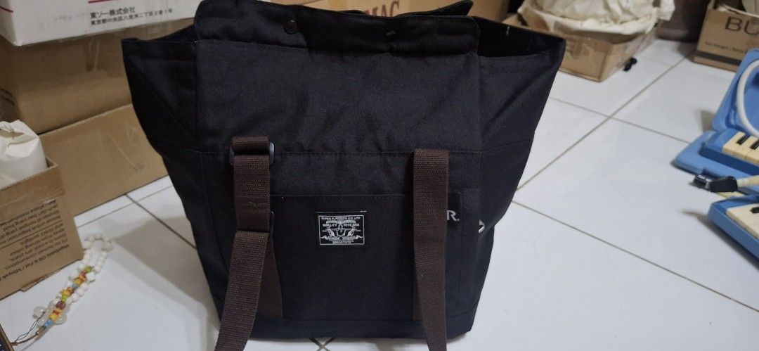 ROOTOTE Quality Tote Bag (Category: Tote Bags) located in Manila. Submitted by youngcloud_b1fffa (Listing ID 1447659650, Image 1). Description: - Black ROOTOTE tote bag - Made by Super Planning Co., Ltd. - Durable material, ideal for everyday use - Features brown straps - Includes practical pockets - Clean and versatile design - Please check photos for detailed condition "R&B Mix Japan Surplus Items".