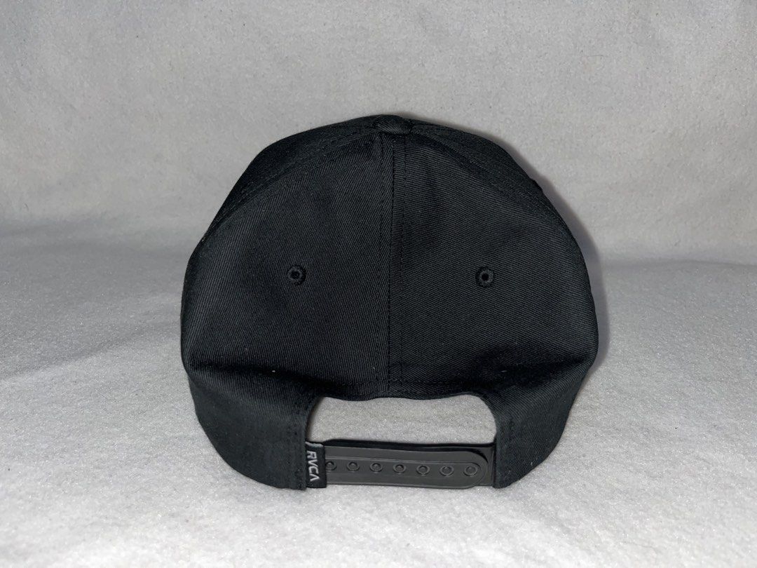RVCA Black Snapback Cap "Fresh Cut" Embroidery (Category: Caps & Hats) located in Alfonso Lista (Potia). Submitted by saintmarysthrift (Listing ID 1447596577, Image 3). Description: - Black RVCA snapback cap - "Fresh Cut" embroidered on front (red & blue) - Adjustable snap closure at back - RVCA logo on back strap - Perfect for everyday wear.