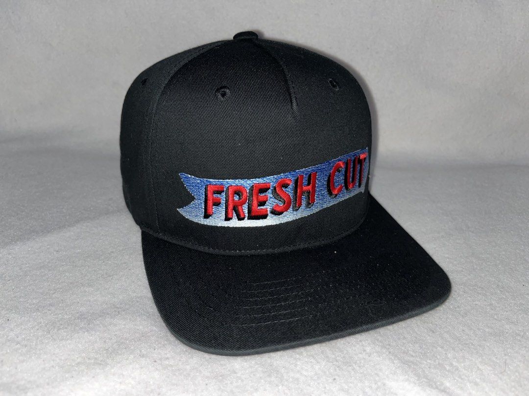 RVCA Black Snapback Cap "Fresh Cut" Embroidery (Category: Caps & Hats) located in Alfonso Lista (Potia). Submitted by saintmarysthrift (Listing ID 1447596577, Image 1). Description: - Black RVCA snapback cap - "Fresh Cut" embroidered on front (red & blue) - Adjustable snap closure at back - RVCA logo on back strap - Perfect for everyday wear.