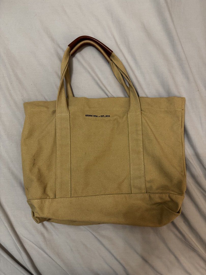 SADDLE ROW Canvas Tote Bag with Bicycle & Oars Graphic (Category: Tote Bags) located in Mandaluyong City. Submitted by ljcasinnn (Listing ID 1447642911, Image 2). Description: - Saddle Row Tan canvas tote bag - Features 'SEALIGN RIDE. ROW. REALIGN 2015' graphic with bicycle and oars - measurement in inches - Leather accents on handles - Interior pocket - Ideal for everyday use or as a beach bag.