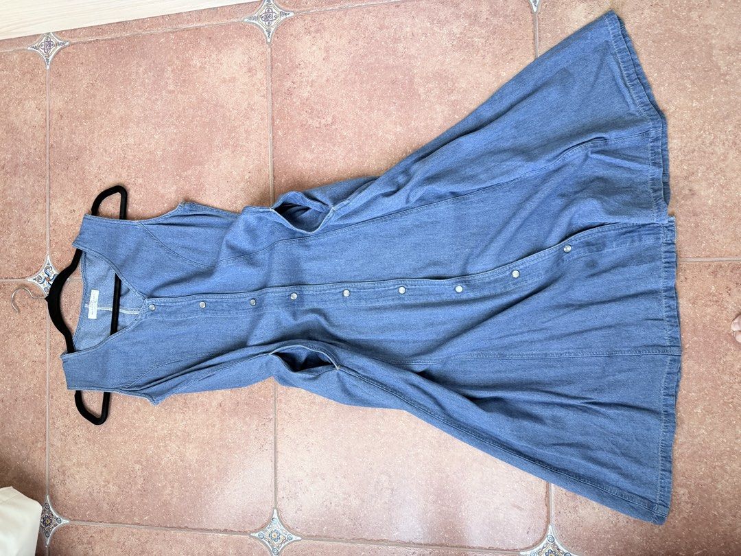 Sleeveless Denim Button-Front Midi Dress (Category: Dresses) located in Cebu City. Submitted by TheSunshineShop (Listing ID 1447514602, Image 3). Description: - Classic blue denim fabric - Sleeveless V-neck design - Full button-front closure - Flattering A-line midi skirt - Convenient side pockets - Versatile for casual outfits or layering.