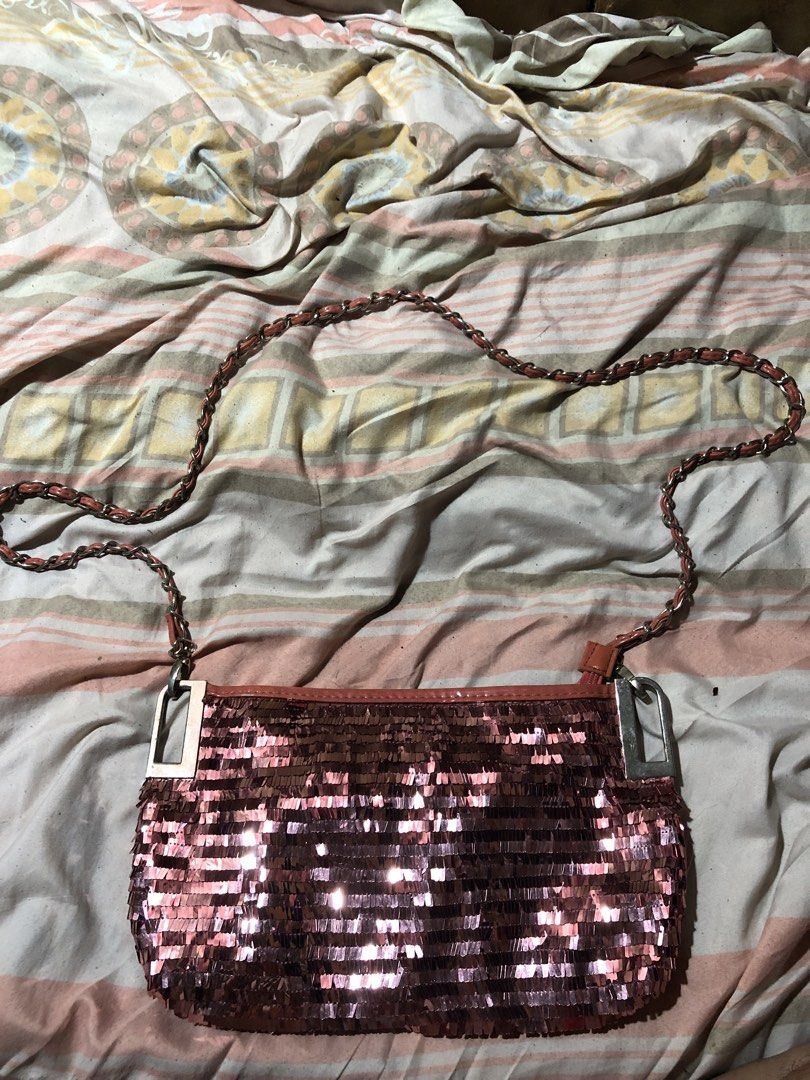Sparkly Rose Gold Shoulder Bag with Chain Strap (Category: Shoulder Bags) located in Manila. Submitted by bakithrift213 (Listing ID 1447630235, Image 1). Description: - Cute sparkly rose gold shoulder bag - Features a chain strap with faux leather detail - Quilted faux leather material on the back - Secure zipper closure - Ideal for nights out or adding glam to any outfit - Approximate dimensions: 9 inches wide x 5 inches tall.