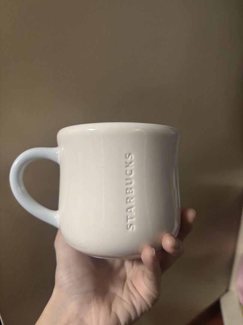 Starbucks Cherry Blossom Mug (Category: Coffee & Tea Tableware) located in Pasig City. Submitted by adiuhsa (Listing ID 1447558832, Image 2). Description: Never nagamit, nakatambak lang bought for 995 - clean only the bottom has a few dirt from making patong - White Starbucks mug - Light blue handle - Cute pink cherry blossom design - Embossed Starbucks logo RFS: decluttering + need funds.