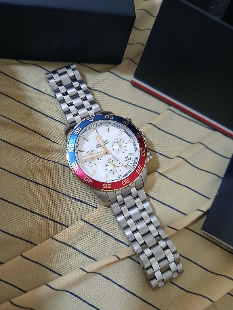 Tommy Hilfiger Chronograph Watch (Category: Men's Watches) located in Quezon City. Submitted by vanlacsa (Listing ID 1447642324, Image 3). Description: - Authentic Tommy Hilfiger Chronograph Watch - Elegant White Dial with Gold Accents - Distinctive Red and Blue Bezel - Durable Stainless Steel Band - Comes with Original Box and Manual - Versatile: Ideal for Everyday or Special Occasions - A Timeless Classic bought last May 2026 16k orig price rfs