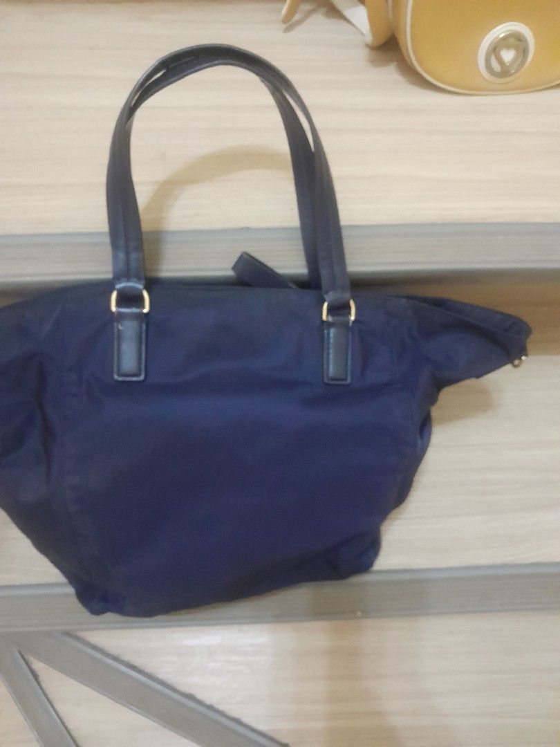 Tory Burch Navy Nylon Tote Bag (Category: Shoulder Bags) located in Angeles City. Submitted by declutterhub (Listing ID 1447494320, Image 2). Description: Navy blue Tory Burch nylon tote bag with leather handles. Features gold hardware, an interior zip pocket, and a slip pocket. Spacious and perfect for daily use..