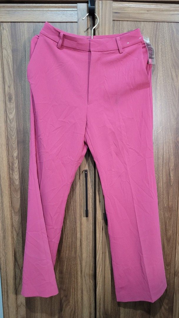 Uniqlo Drape Flared Pants - Pink (Category: Other Bottoms) located in Davao. Submitted by NearlyNew (Listing ID 1447507456, Image 2). Description: - Brand new Uniqlo Drape Flared Pants - Color: Pink - Size: 155/62A (Waist 61cm, Hip 88cm) - Material: 100% Polyester - Design: Flared leg - Versatile: Great for casual or dressy outfits - Condition: Brand new, no tag, extra buttons - Best fits XS to S.
